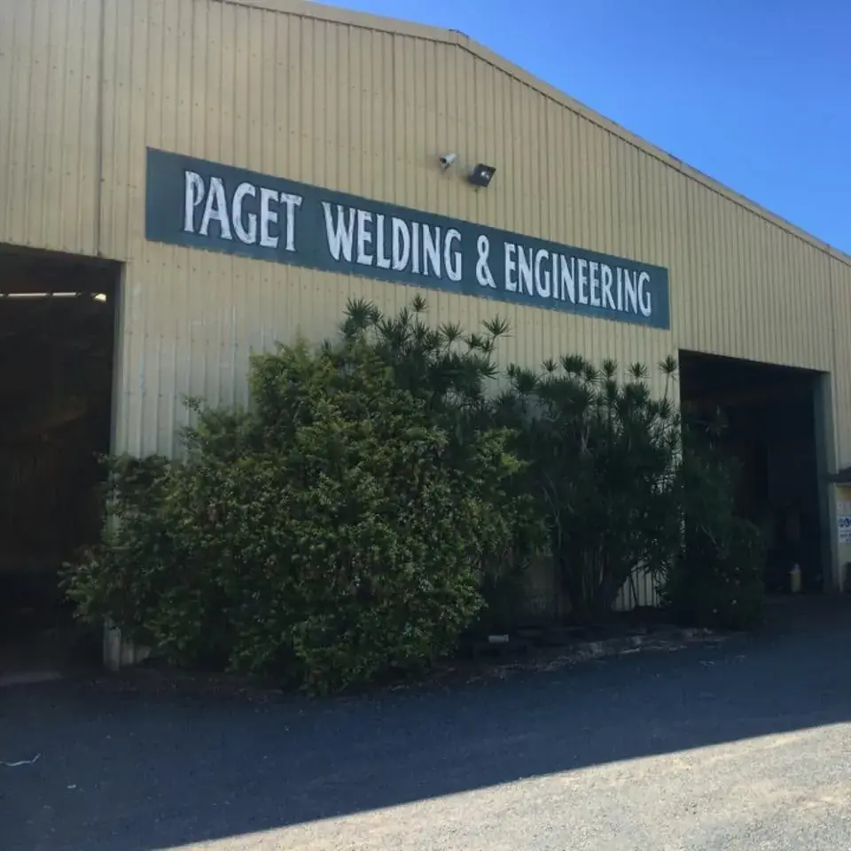 The Paget Welding & Engineering workshop from the street, business signage across the shed frontage